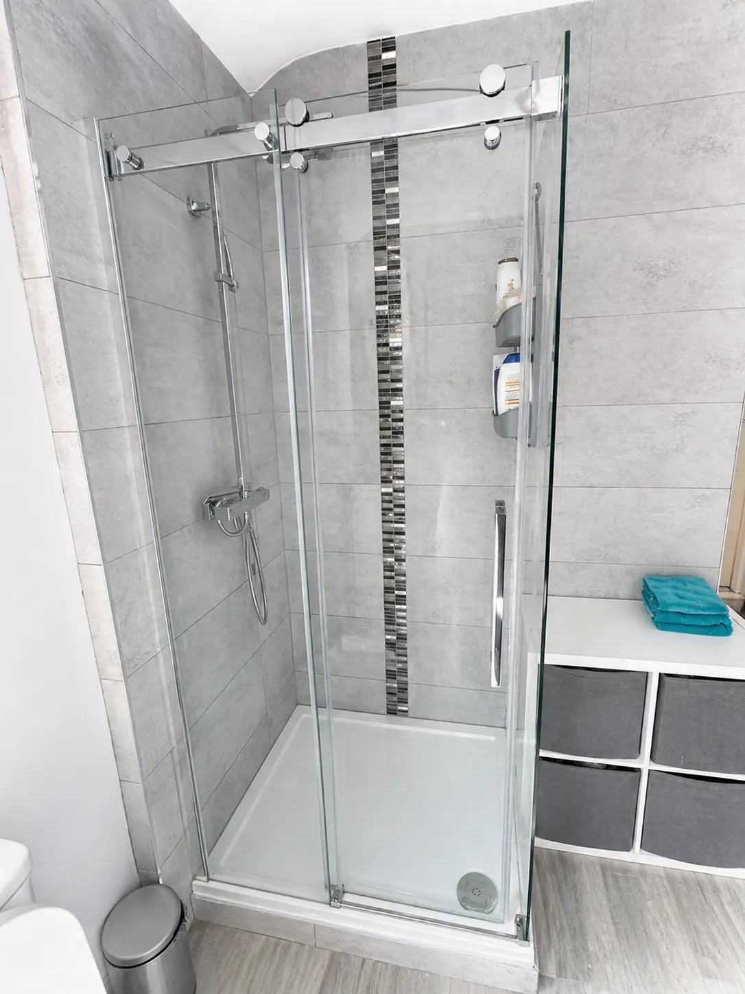 Clean glass shower enclosure after professional bathroom cleaning.